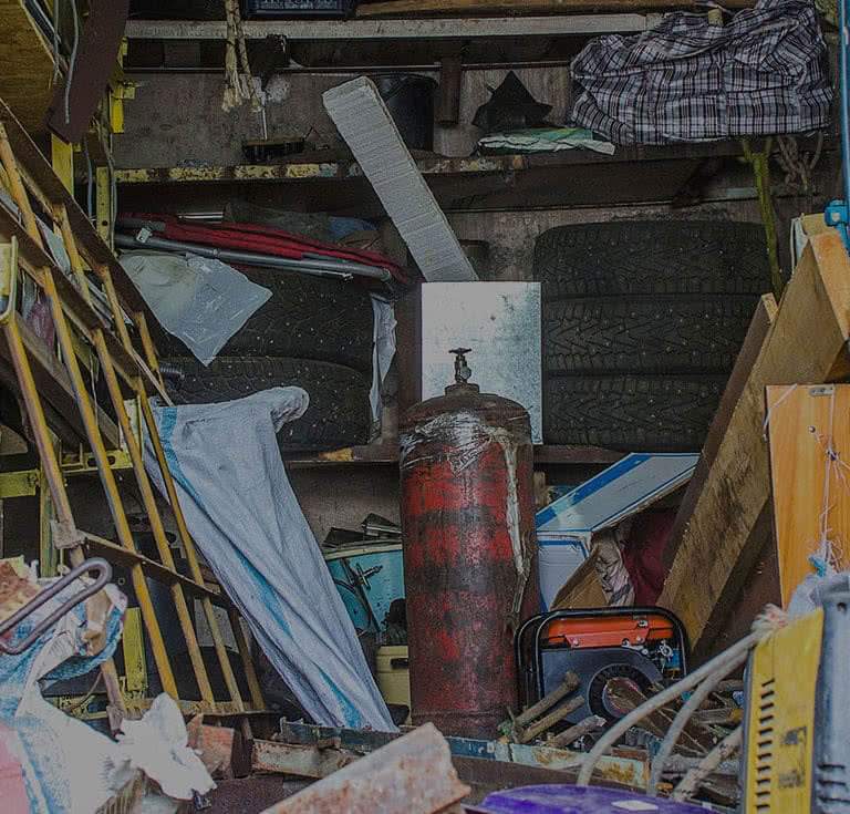 A garage filled with handiwork related junk and garbage